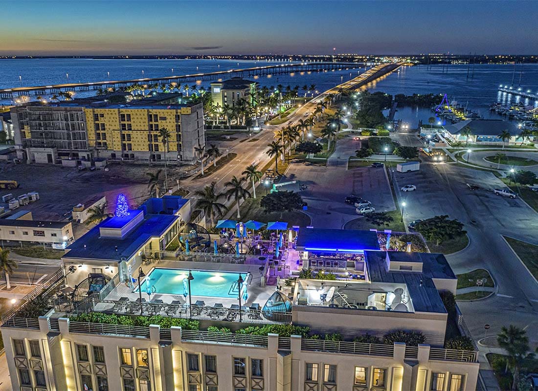 Port Charlotte, FL - Aerial View of Hotels and Condo Buildings in the Evening By the Water in Port Charlotte Florida